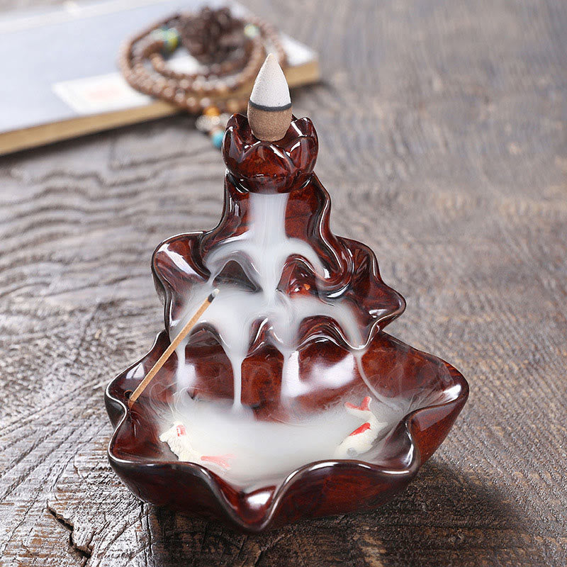 Lotus Leaf Koi Fish Incense Burner – reddish-brown glossy lotus, koi in smoke, mala on book, meditation