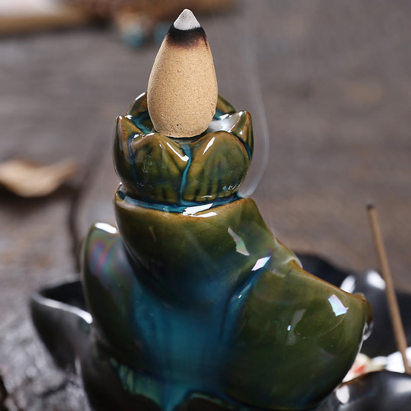 Lotus Leaf Koi Fish Incense Burner – sculpted koi in deep teal lotus, thin smoke wisps, feng shui