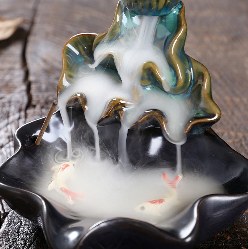 Lotus Leaf Koi Fish Incense Burner – two koi in swirling smoke pool, weathered wood close-up, prosperity