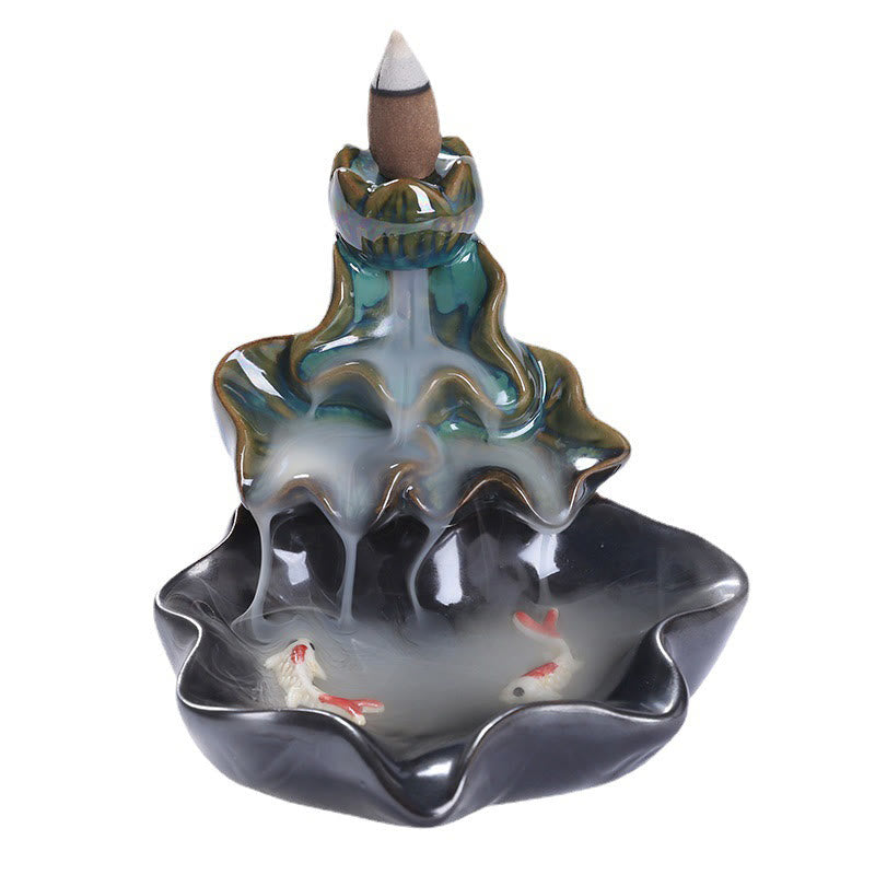 Lotus Leaf Koi Fish Incense Burner – iridescent teal lotus, two koi in smoke, white background, backflow