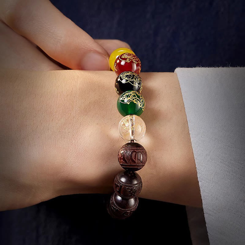 Five Directions Wealth Bracelet - Bracelet worn on wrist with formal attire, five-element gemstone beads in sharp focus