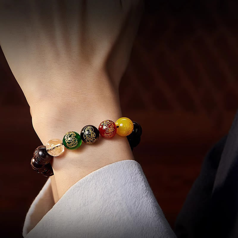 Five Directions Wealth Bracelet - Close-up wrist wear with gold dragon motif on jade bead, moody lighting, luxury feel