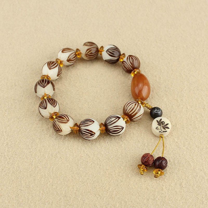 Tibetan Mala Bodhi Seed Lotus Bracelet - overhead flatlay, lotus carved beads, amber spacers