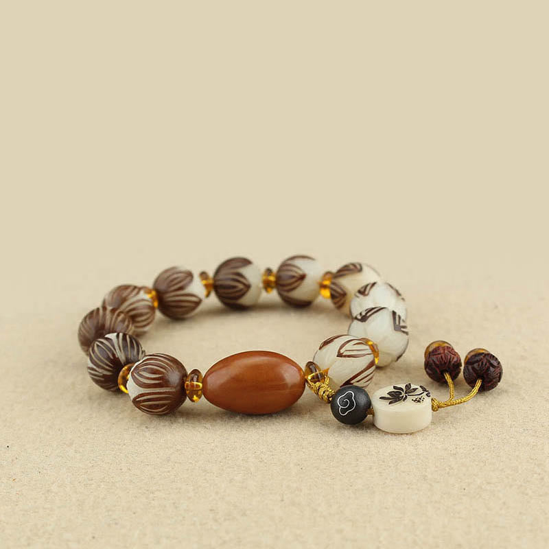 Tibetan Mala Bodhi Seed Lotus Bracelet - three-quarter angle, lotus beads and dangle charm, mindful