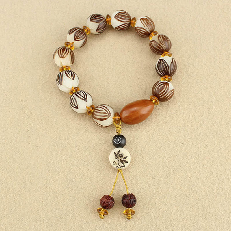 Tibetan Mala Bodhi Seed Lotus Bracelet - overhead flatlay, lotus carved beads, full tassel