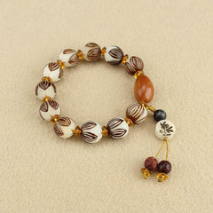 Tibetan Mala Bodhi Seed Lotus Bracelet - overhead flatlay, lotus carved beads, amber spacers