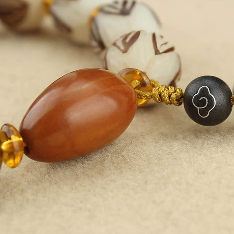 Tibetan Mala Bodhi Seed Lotus Bracelet - macro oval center bead, gold cord, carved detail