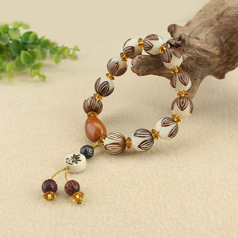 Tibetan Mala Bodhi Seed Lotus Bracelet - on driftwood, lotus beads, dangle charm detail