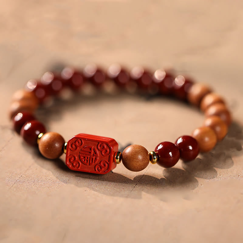 Cinnabar Wood Lotus Fu Bracelet - carved Fu blessing bead close-up, gold spacers, lucky