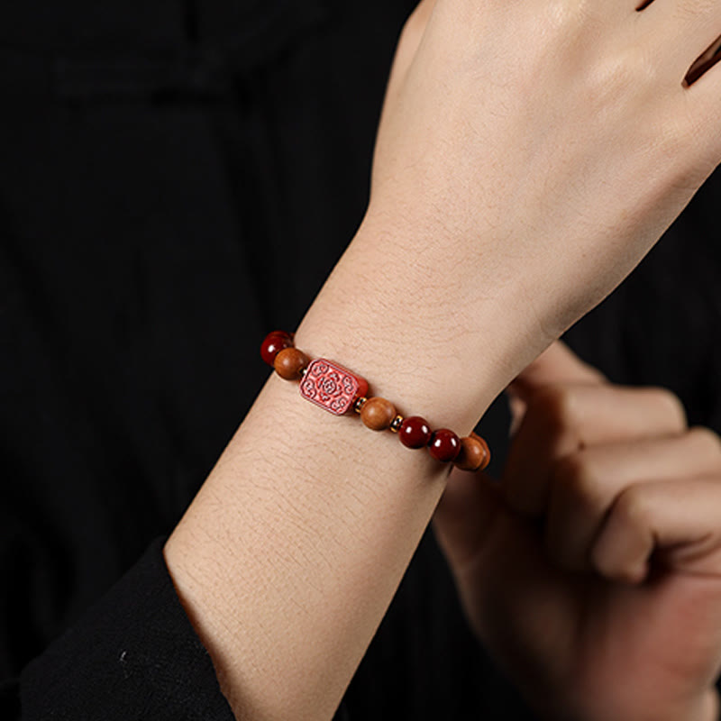 Cinnabar Wood Lotus Fu Bracelet - worn on wrist, dark bg, Fu charm visible, refined