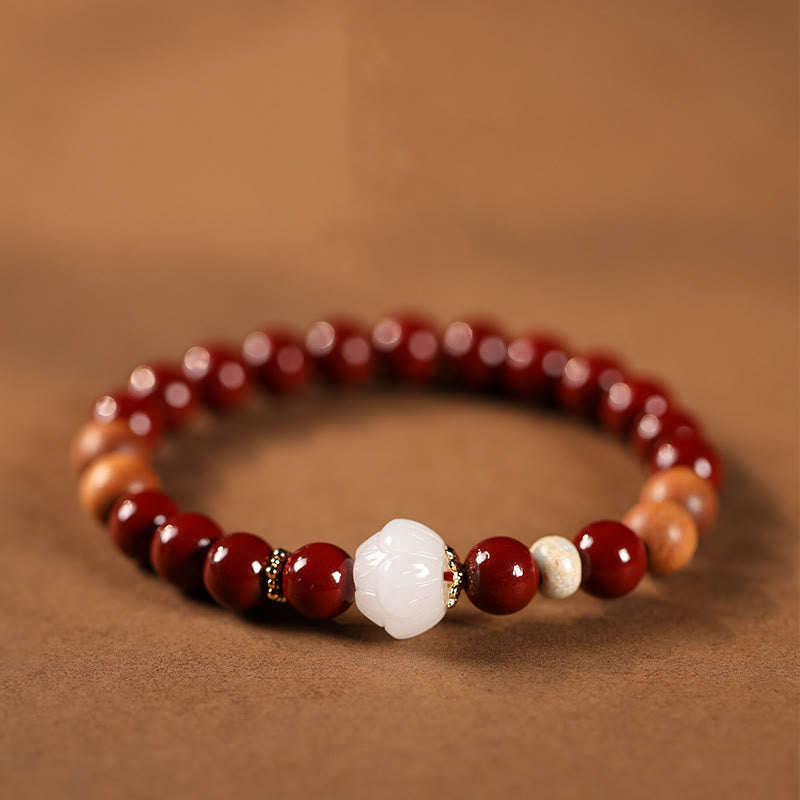 Cinnabar Wood Lotus Fu Bracelet - red beads with carved white lotus center on brown, spiritual
