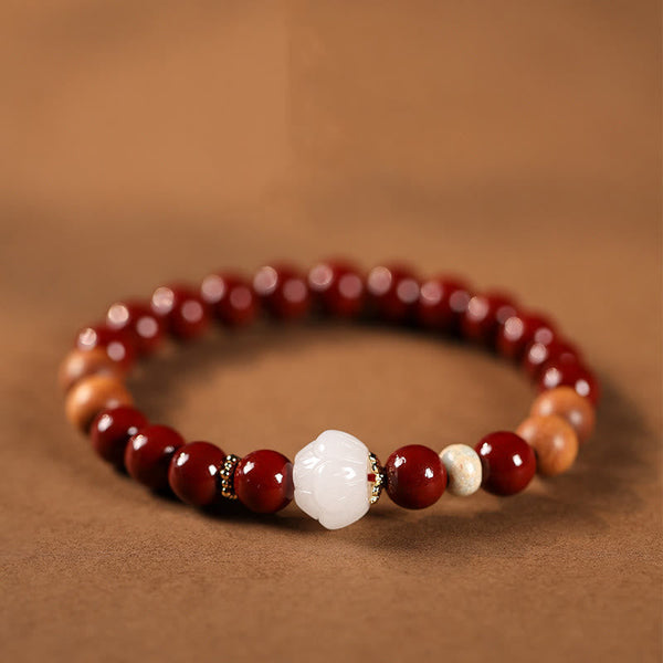 Cinnabar Wood Lotus Fu Bracelet - red beads with carved white lotus center on brown, spiritual