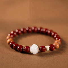 Cinnabar Wood Lotus Fu Bracelet - red beads with carved white lotus center on brown, spiritual