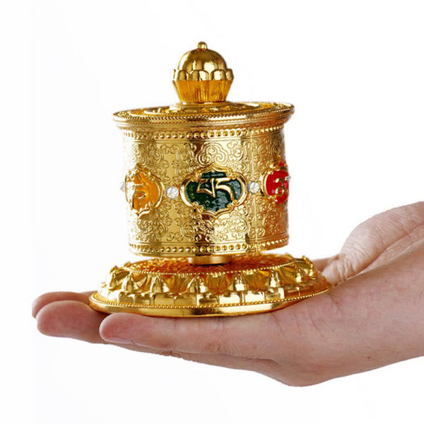 Lotus Prayer Wheel - Compact brass wheel resting on palm, handheld Buddhist meditation tool