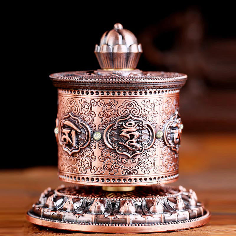 Lotus Prayer Wheel - Low-angle view of incised mantras and scrollwork on bronze, car decor
