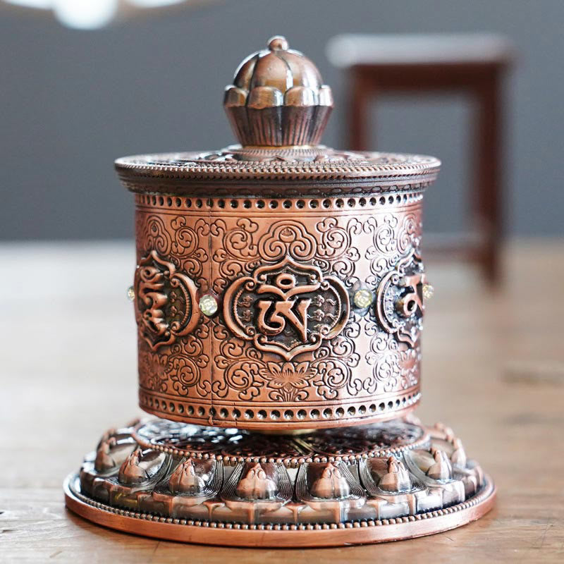 Lotus Prayer Wheel - Eye-level view on light wood with lotus base, tranquil home spiritual decor