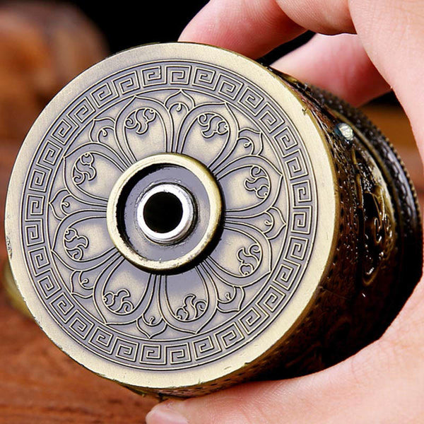 Lotus Prayer Wheel - Top-down view of engraved lotus mandala and meander border, craftsmanship