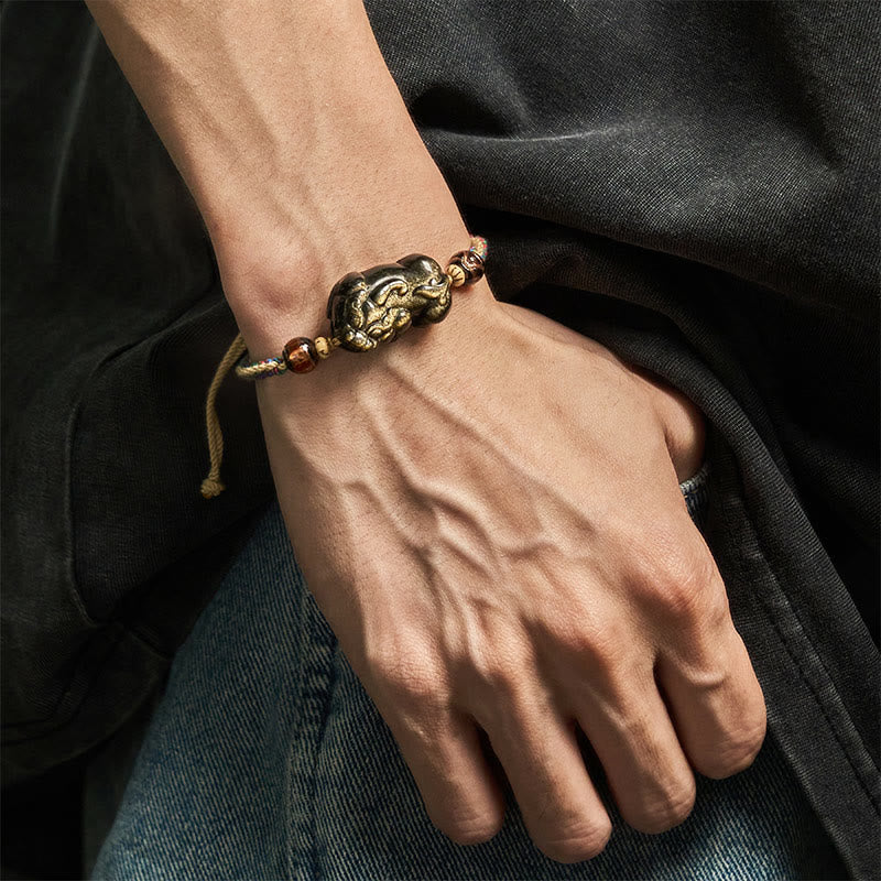Gold Sheen Obsidian PiXiu bracelet – worn on male wrist with dark shirt jeans, wealth protection