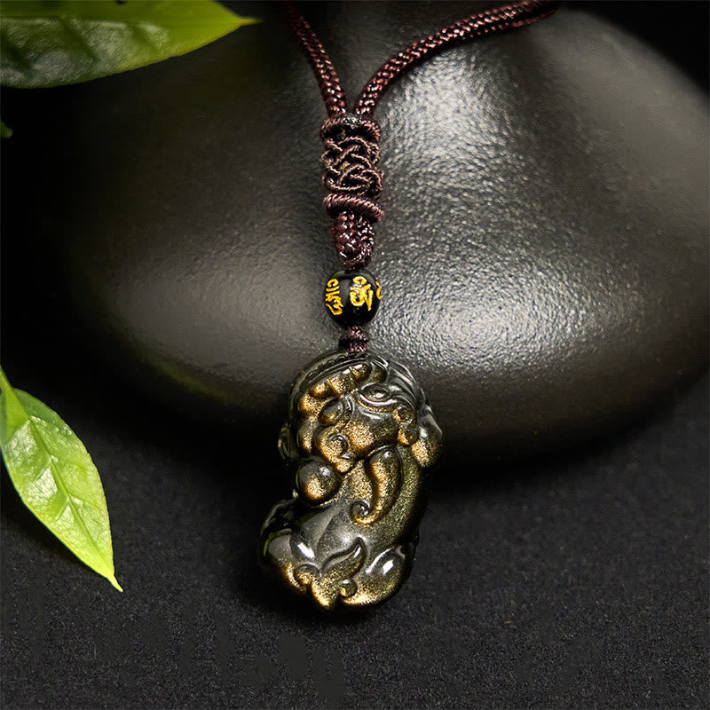 Gold Sheen Obsidian PiXiu Wealth Rope Necklace Pendant – hanging against black stone, green leaf accent, obsidian necklace