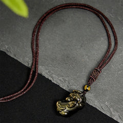 Gold Sheen Obsidian PiXiu Wealth Rope Necklace Pendant – full maroon rope necklace on slate, wealth talisman pendant gift