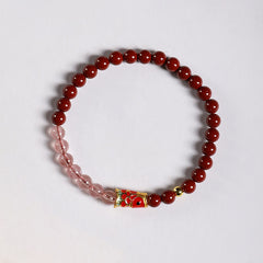 Cinnabar Strawberry Quartz Koi Fish Bracelet – top-down flat lay, cinnabar pink beads, koi