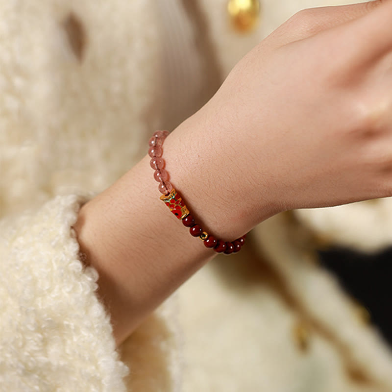Cinnabar Strawberry Quartz Koi Fish Bracelet – worn on wrist, pink quartz cinnabar, lifestyle