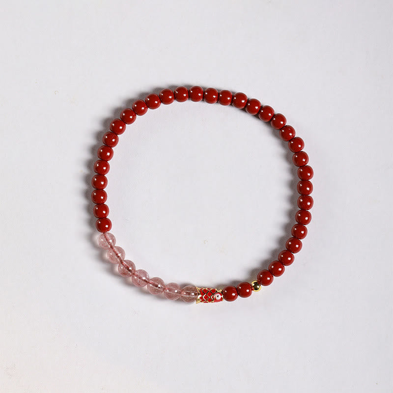 Cinnabar Strawberry Quartz Koi Fish Bracelet – flat lay, red and pink beads with koi, white bg