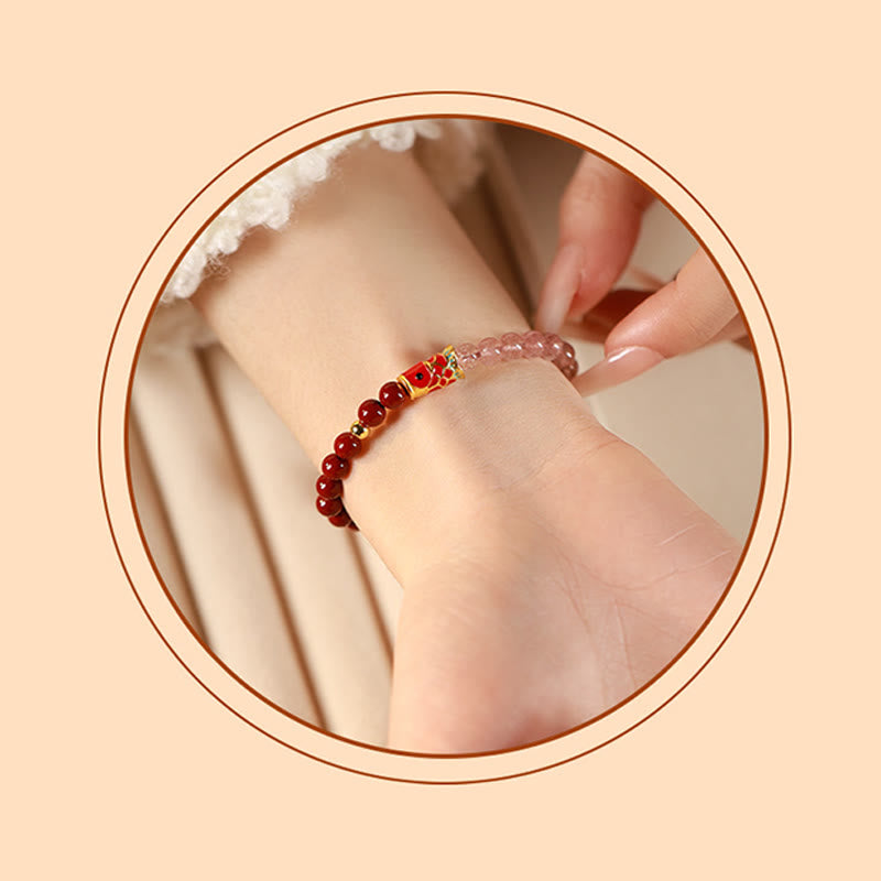 Cinnabar Strawberry Quartz Koi Fish Bracelet – on wrist in circular frame, hand touching, koi
