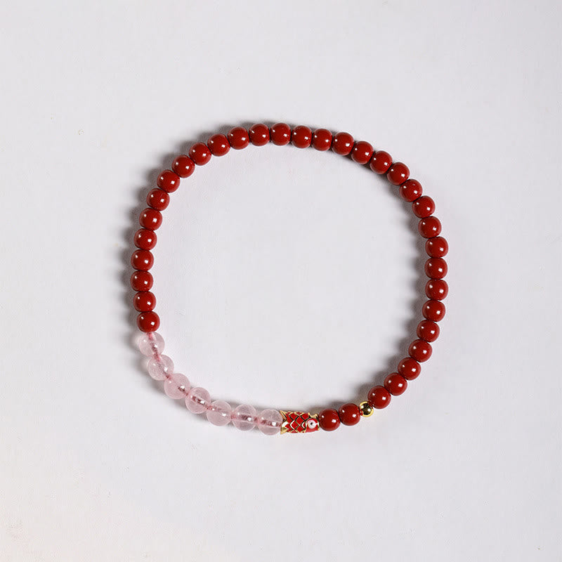 Cinnabar Strawberry Quartz Koi Fish Bracelet – flat lay, deep red cinnabar pink quartz, koi