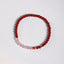 Cinnabar Strawberry Quartz Koi Fish Bracelet – flat lay, deep red cinnabar pink quartz, koi