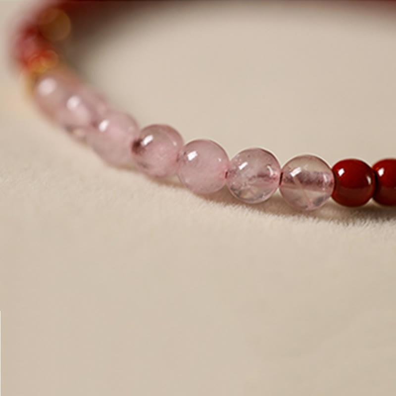 Cinnabar Strawberry Quartz Koi Fish Bracelet – macro pink quartz and red beads, low angle