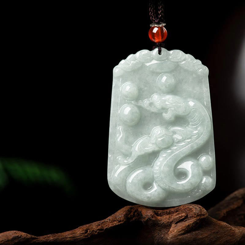 Natural Jade Zodiac Amulet Pendant – Qilin dragon-horse jade relief on dark fabric angled view, Noble