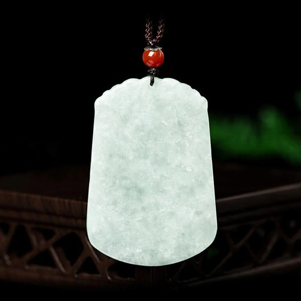 Natural Jade Zodiac Amulet Pendant – Frontal view jade plaque on dark wood with red agate bead knot, Auspicious