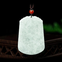 Natural Jade Zodiac Amulet Pendant – Frontal view jade plaque on dark wood with red agate bead knot, Auspicious