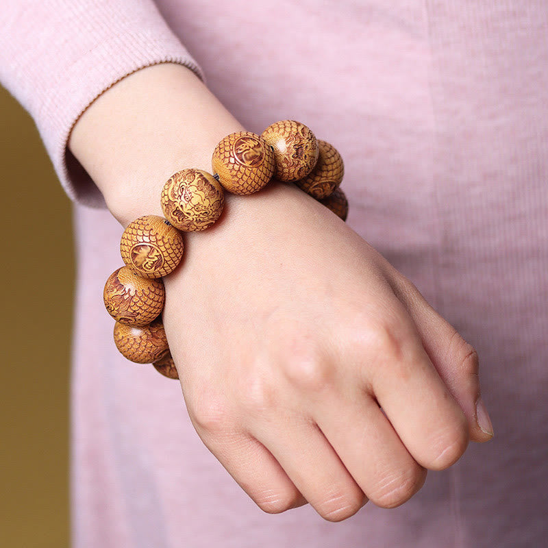 Sandalwood Dragon Bracelet – wooden beads with fortune symbols worn on wrist, Grounding