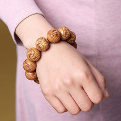 Sandalwood Dragon Bracelet – wooden beads with fortune symbols worn on wrist, Grounding