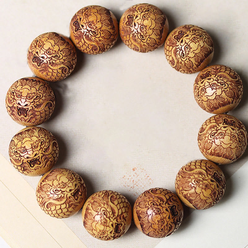 Sandalwood Dragon Bracelet – round carved guardian lion wood beads flat lay, Protection