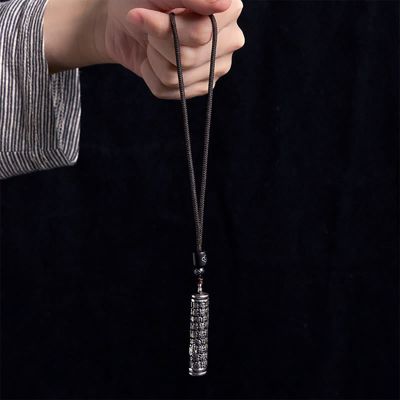 Copper Dragon Fu Character Pendant – engraved cylinder held on black background, Meditation