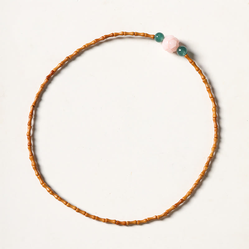 Olive Pit Lotus Double Circle Bracelet – overhead flat-lay on white background with pink lotus center, Olive Pit