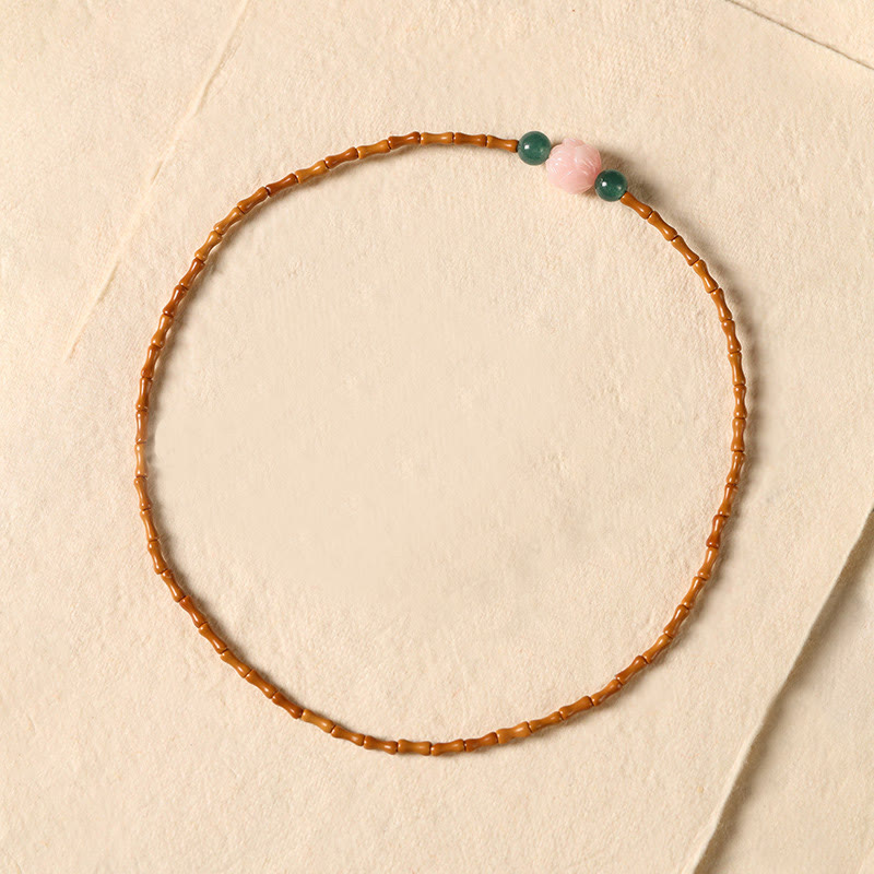 Olive Pit Lotus Double Circle Bracelet – flat-lay top-down on cream paper showing full circular bead arrangement, Minimalist