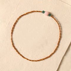 Olive Pit Lotus Double Circle Bracelet – flat-lay top-down on cream paper showing full circular bead arrangement, Minimalist