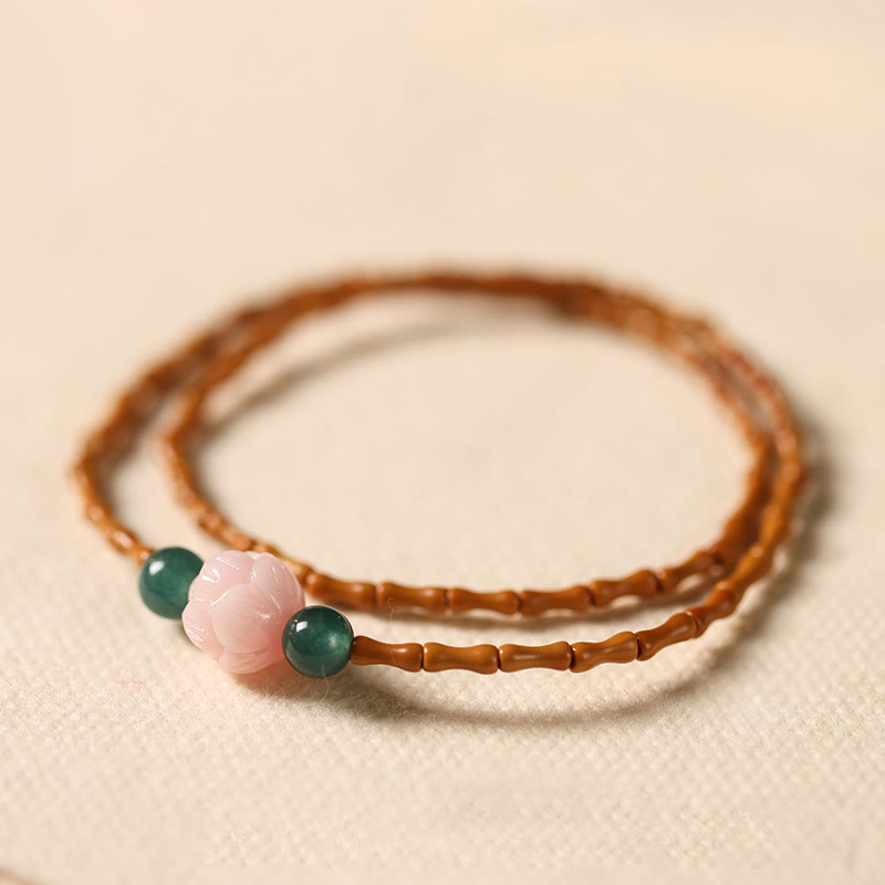 Olive Pit Lotus Double Circle Bracelet – double-strand olive pit beads with carved lotus and jade on cream linen, Mindful