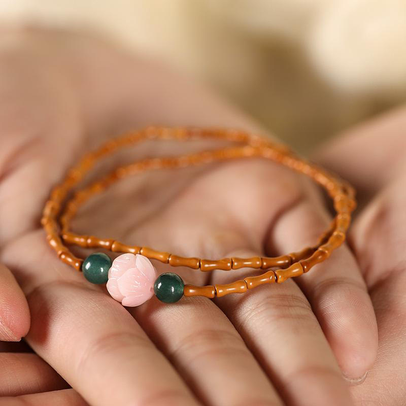 Olive Pit Lotus Double Circle Bracelet – bracelet cupped in palm showing green jade and pink lotus focus, Peaceful