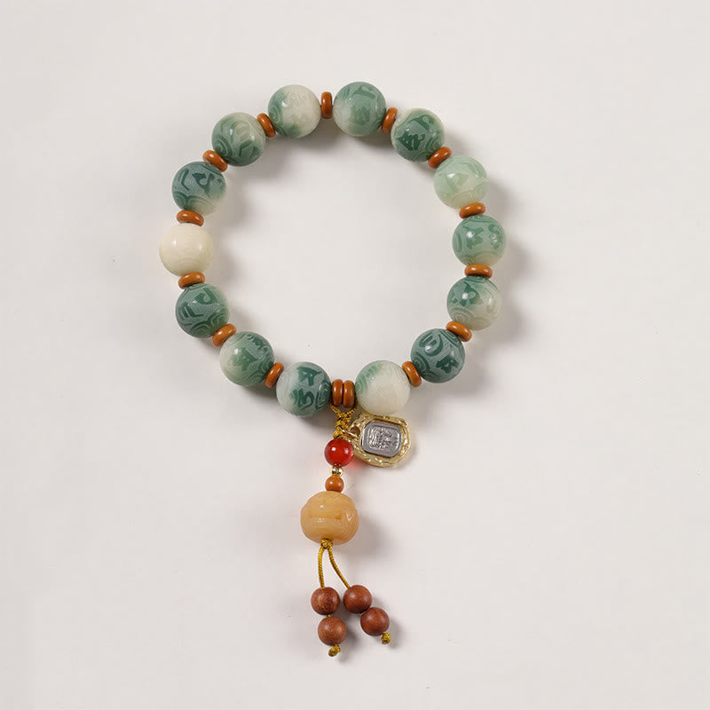 Bodhi Seed Zakiram Bracelet - Flat lay top-down view of full circular strand with tassel dangle, prayer bead bracelet