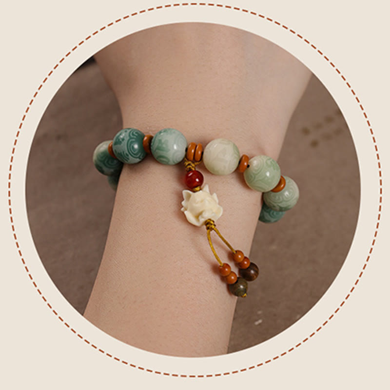 Bodhi Seed Zakiram Bracelet - Wrist close-up in circular frame showing lotus charm and stone texture, meditation bracelet