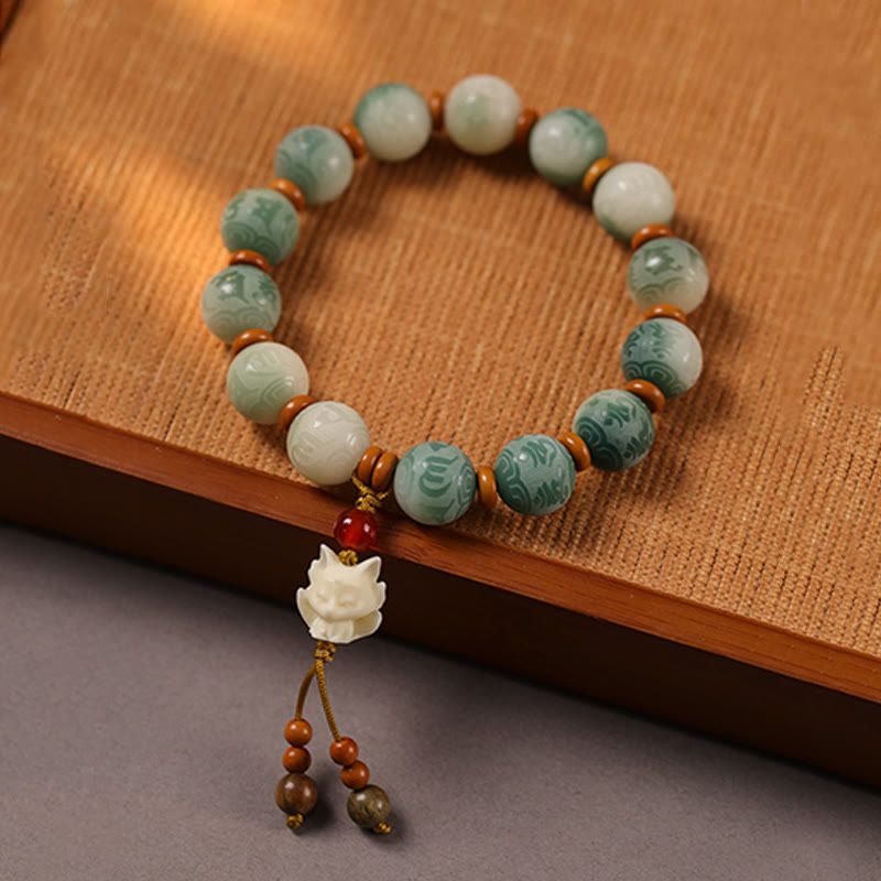 Bodhi Seed Zakiram Bracelet - On bamboo mat with carved fox charm and teardrop beads, bohemian beaded bracelet