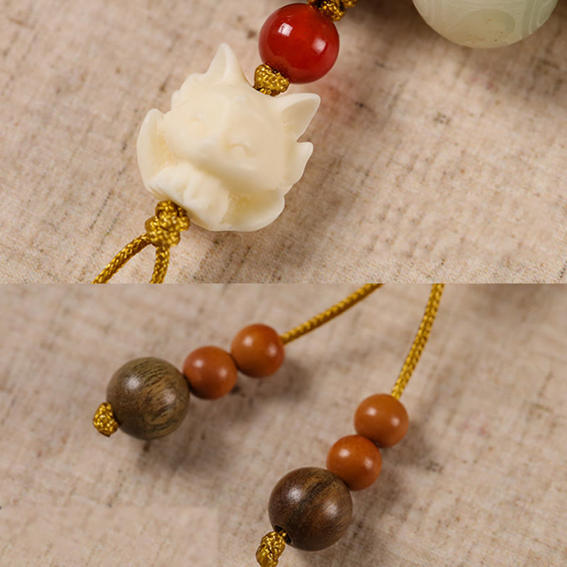 Bodhi Seed Zakiram Bracelet - Macro detail of carved fox head with red carnelian and wood beads, handmade bracelet