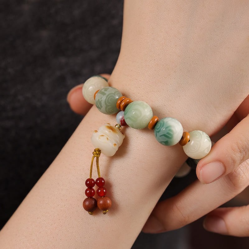 Bodhi Seed Zakiram Bracelet - Worn on wrist showing carved animal charm and natural bead texture, lifestyle mala bracelet