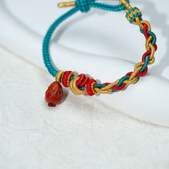 Natural Red Agate PiXiu Braided Bracelet – knot detail on white stone texture, handcrafted bracelet