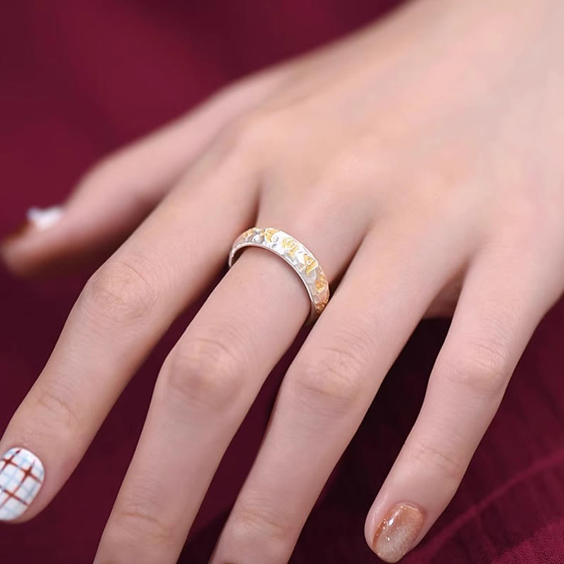 Hammered Om Mani Padme Hum Ring - worn on finger with burgundy velvet, artisan mantra ring